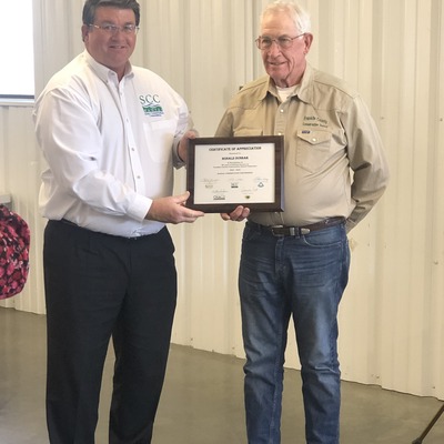 Ron Dunbar receiveing 20 year service award from SCC Commissioner John Wunder